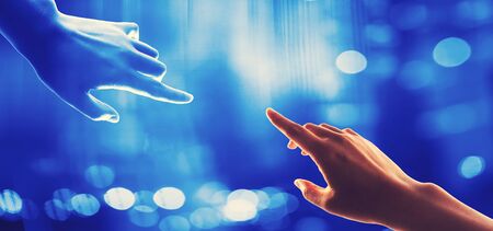 Tow hands touching on a shiny blue background