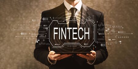 Fintech concept with businessman holding a tablet computerの写真素材