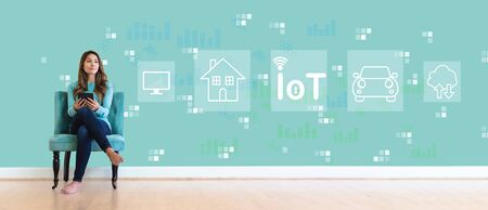 IoT theme with young woman holding a tablet computerの写真素材