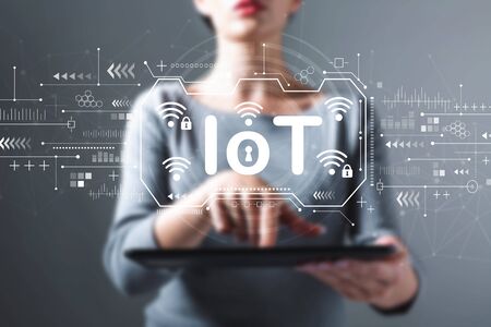 IoT theme with business woman using a tablet computerの写真素材