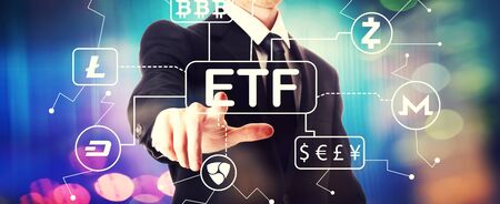 Cryptocurrency ETF theme with a businessman on a shiny backgroundの写真素材