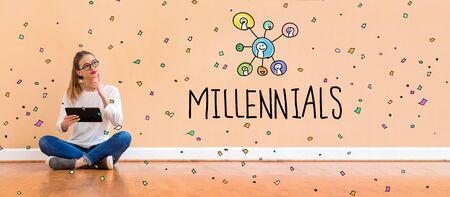 Millennials with young woman holding a tablet computerの写真素材