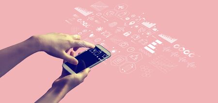 Travel theme with person holding a white smartphoneの写真素材