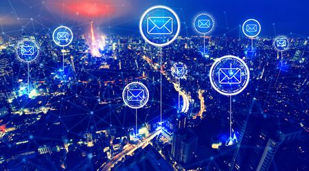 Emails with aerial view of Tokyo, Japan at nightの写真素材