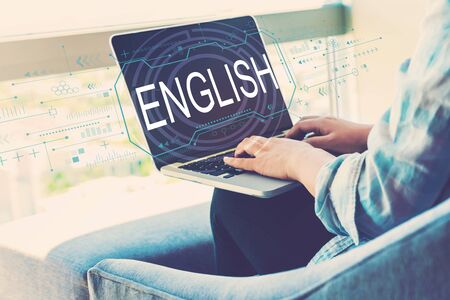 English concept with woman using her laptop in her home officeの写真素材