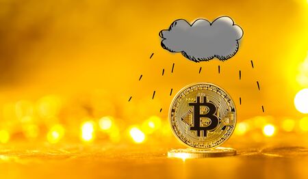Rain cloud with gold bitcoin cryptocurrency coinの写真素材