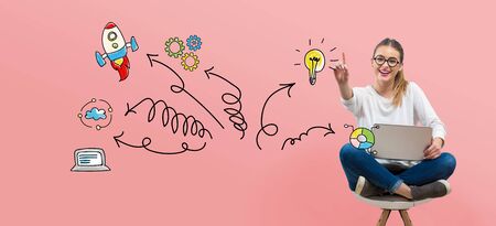 Direction arrows with young woman using her laptopの写真素材