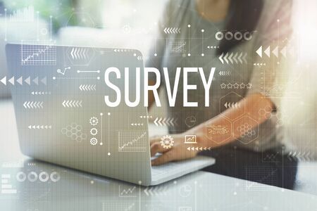 Survey with woman using her laptop in her home officeの写真素材