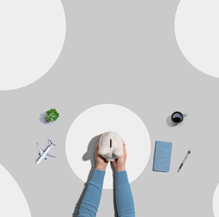 Person holding a piggy bank from aboveの写真素材