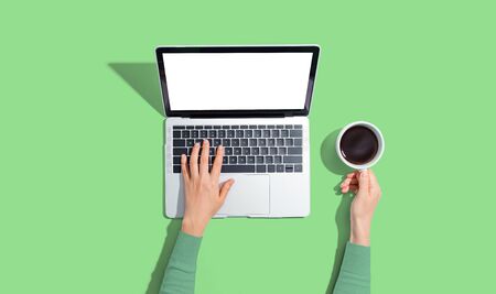 Person using a laptop computer from aboveの写真素材