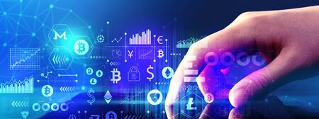 Cryptocurrency theme with hand pressing tablet computer screenの写真素材