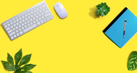 Computer keyboard and mouse with notebook from aboveの写真素材