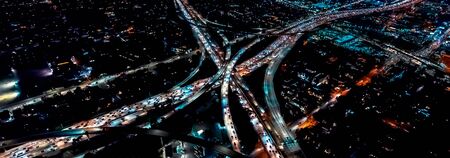 Aerial view of a massive highway in Los Angeles, CA at nightの写真素材
