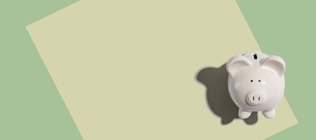 A white piggy bank overhead view flat lay