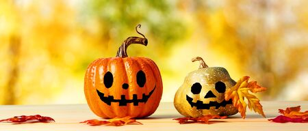 Halloween pumpkins with an autumn sky and foliage backgroundの写真素材