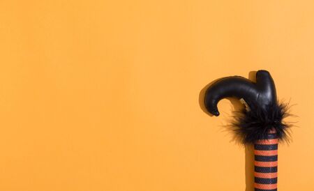 Halloween theme with witches leg decoration on a orange backgroundの写真素材