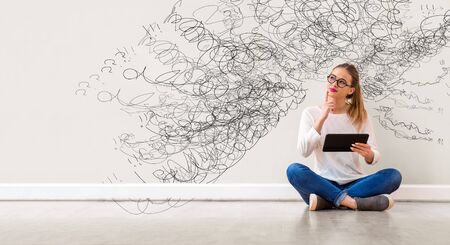 Confused concept with young woman holding a tablet computer