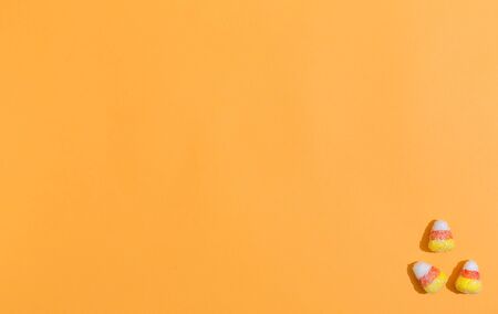 Halloween theme with candies on a orange background
