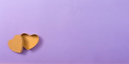 Big heart gift box on a purple paper backgroundの写真素材
