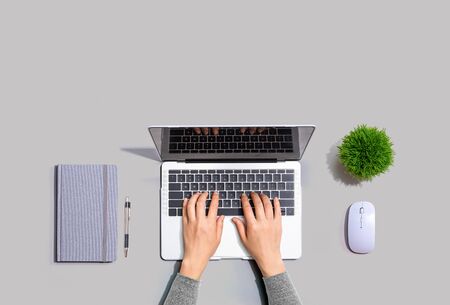 Person using a laptop computer from aboveの写真素材