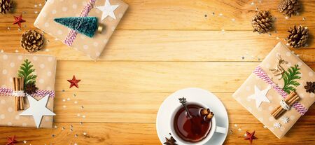 Christmas gift boxes with a cup of tea - flat lay