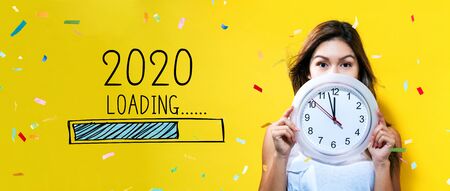 Loading new year 2020 with young woman holding a clock showing nearly 12