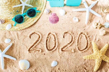 2020 text in the sand with beach accessoriesの写真素材