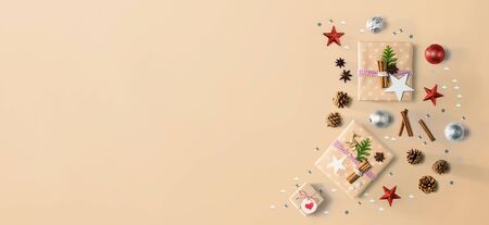 Handmade Christmas gift boxes with ornaments - flat lay