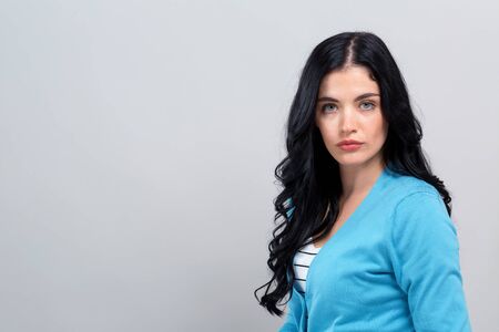 Portrait of a young woman on a gray backgroundの写真素材