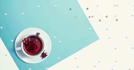 Cinnamon tea with star confetti - flat lay
