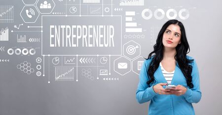 Entrepreneur concept with thoughtful young woman holding a smartphoneの写真素材