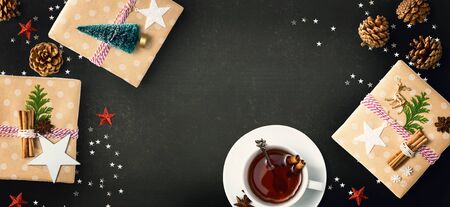 Christmas gift boxes with a cup of tea - flat lay