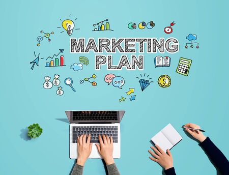 Marketing plan with people working together with laptop and notebookの写真素材