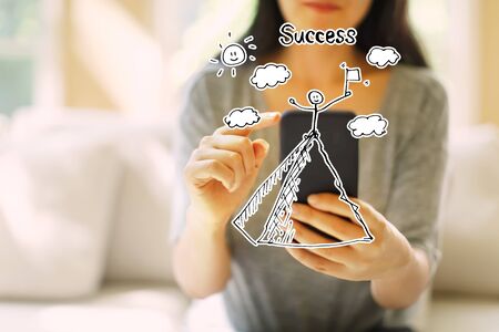 Standing on the top of a mountain with woman using her smartphone in a living roomの写真素材
