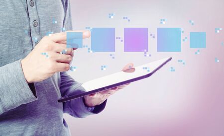 Digital square boxes with man holding a tablet computer
