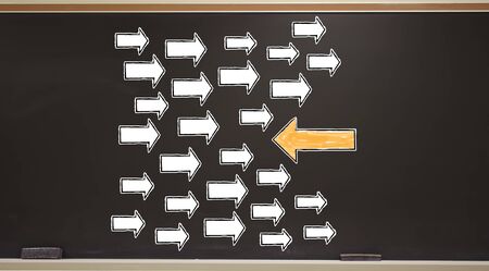 Arrow going in a opposite direction on a blackboard with erasers