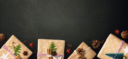 Handmade Christmas gift boxes with ornaments - flat layの写真素材