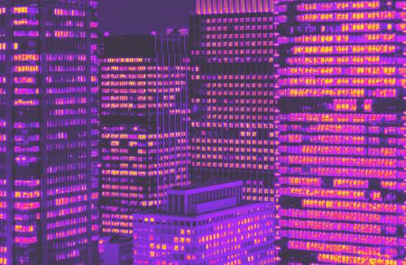 Skyscrapers illuminated at night in Tokyo, Japan synth wave styleの写真素材