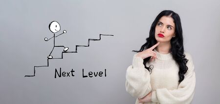 Next level concept with young woman in a thoughtful faceの写真素材