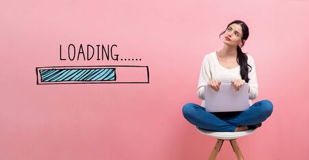 Loading concept with young woman using a laptop computerの写真素材