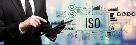 ISO concept with businessman using his tablet computerの写真素材
