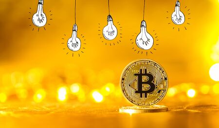 Idea light bulbs with gold bitcoin cryptocurrency coin
