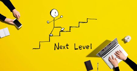 Next level concept with people working together with laptop and phoneの写真素材