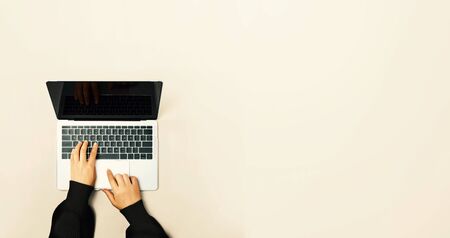 Person using a laptop computer from aboveの写真素材