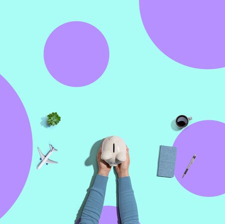 Person holding a piggy bank from aboveの写真素材