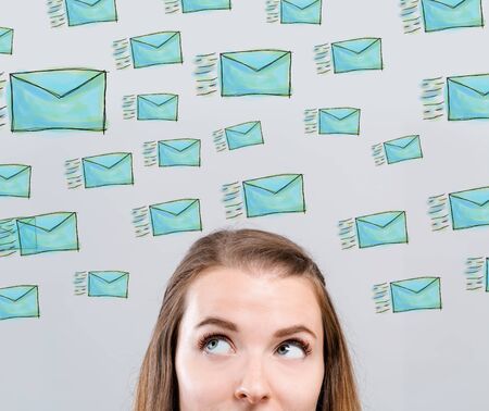 Many sketch emails with young woman looking upwardsの写真素材