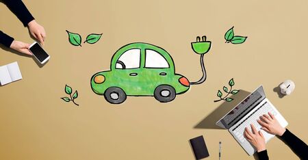 Electric car with people working together with laptop and phoneの写真素材