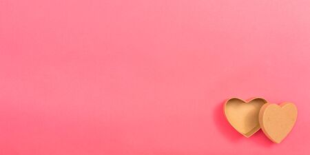 Heart gift box on a pink paper backgroundの写真素材