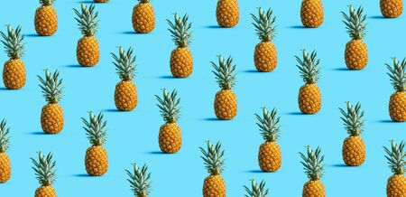 Many pineapples on a solid color backgroundの写真素材