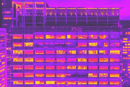 Skyscrapers illuminated at night in Tokyo, Japan synth wave styleの写真素材